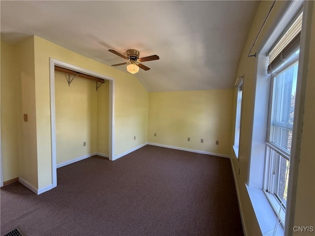 320 W 3rd St, Oswego-City, NY 13126 - unfurnished bedroom with dark colored carpet, multiple windows, lofted ceiling, and a ceiling fan