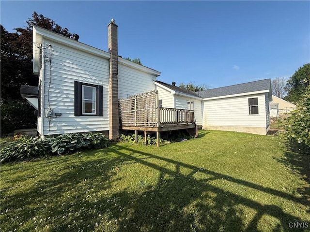 320 W 3rd St, Oswego-City, NY 13126 - back of house featuring a wooden deck, a yard, and a chimney