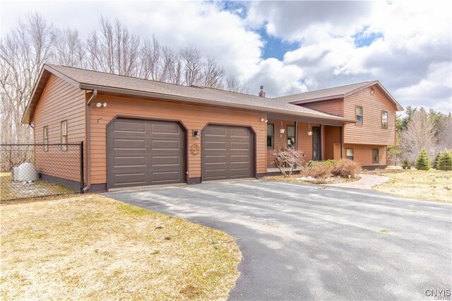 18644 Woodruff Settlement Rd, Watertown-Town, NY 13601 - tri-level home featuring asphalt driveway and an attached garage
