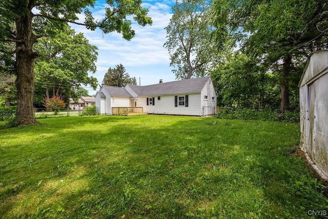 9 Lawrence Ave, New Hartford, NY 13413 - rear view of house with a fenced backyard