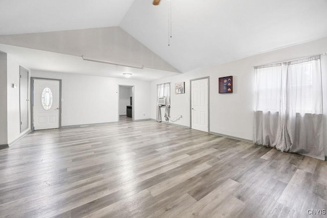 9 Lawrence Ave, New Hartford, NY 13413 - unfurnished living room with lofted ceiling, light wood finished floors, and ceiling fan
