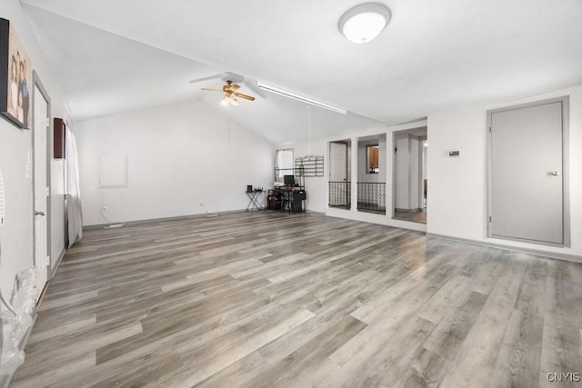 9 Lawrence Ave, New Hartford, NY 13413 - unfurnished living room with light wood-type flooring, a ceiling fan, and vaulted ceiling