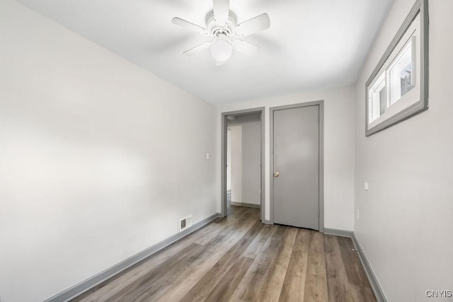 9 Lawrence Ave, New Hartford, NY 13413 - unfurnished bedroom with light wood finished floors and ceiling fan