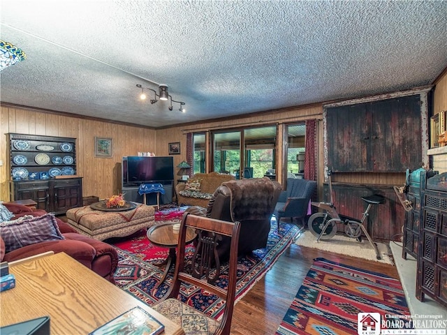 5152 John Darling Rd, Conowingo, NY 14726 - living room with wood finished floors, wooden walls, and a textured ceiling