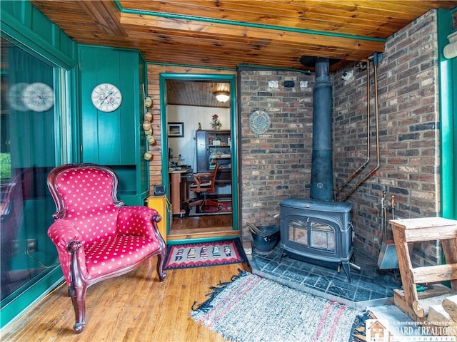 5152 John Darling Rd, Conowingo, NY 14726 - sitting room featuring wood ceiling, a wood stove, and wood finished floors