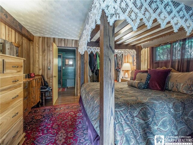 5152 John Darling Rd, Conowingo, NY 14726 - bedroom featuring wooden walls and wood finished floors