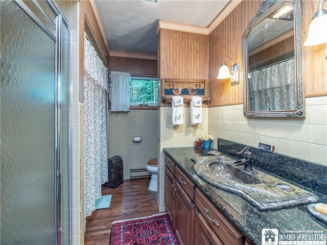 5152 John Darling Rd, Conowingo, NY 14726 - full bathroom featuring a baseboard radiator, tile walls, crown molding, vanity, and wood finished floors