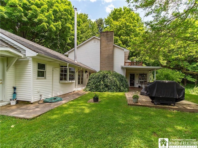 5152 John Darling Rd, Conowingo, NY 14726 - rear view of property featuring a wooden deck, a lawn, and a patio