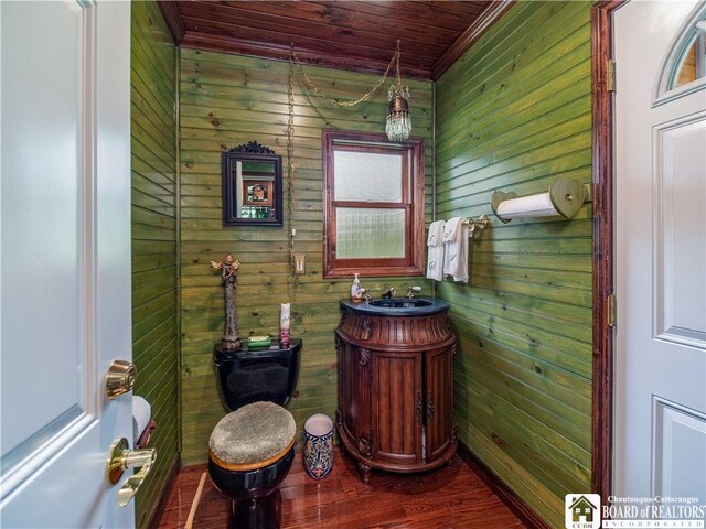 5152 John Darling Rd, Conowingo, NY 14726 - bathroom featuring wooden walls, wood ceiling, vanity, ornamental molding, and wood finished floors