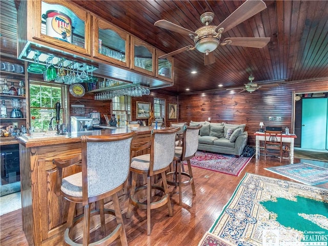 5152 John Darling Rd, Conowingo, NY 14726 - bar with a ceiling fan, wooden walls, wooden ceiling, wood finished floors, and wine cooler