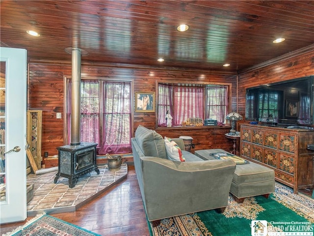 5152 John Darling Rd, Conowingo, NY 14726 - living area with a wood stove, healthy amount of natural light, wood-type flooring, wooden ceiling, and wood walls