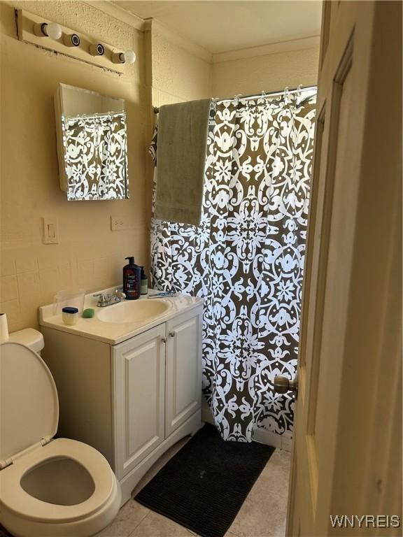 54 Decker St, Buffalo, NY 14215 - full bathroom featuring vanity, a shower with shower curtain, ornamental molding, and tile patterned flooring