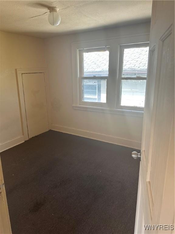 54 Decker St, Buffalo, NY 14215 - spare room featuring dark colored carpet and a textured ceiling