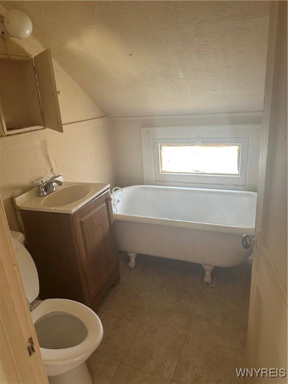 54 Decker St, Buffalo, NY 14215 - bathroom with a soaking tub, a textured ceiling, tile patterned floors, and vanity