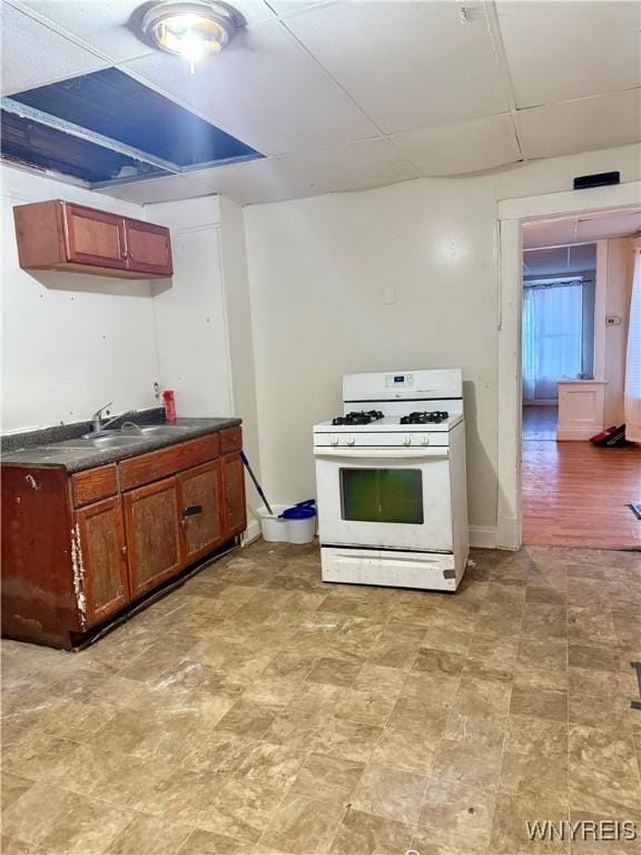 246 Cambridge Ave, Buffalo, NY 14215 - kitchen with gas range gas stove, dark countertops, and a paneled ceiling