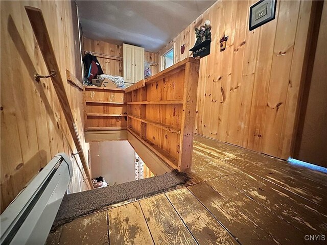 5767 W Main St, West Turin, NY 13325 - detailed view of wood walls, baseboard heating, and wood finished floors