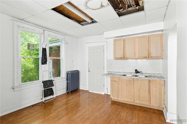 49 Urban St, Buffalo, NY 14211 - kitchen featuring radiator, light brown cabinets, wood finished floors, and light countertops