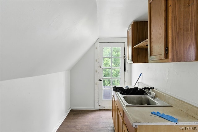 49 Urban St, Buffalo, NY 14211 - kitchen with lofted ceiling, wood finished floors, light countertops, and brown cabinets
