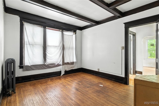 49 Urban St, Buffalo, NY 14211 - spare room with radiator heating unit, hardwood / wood-style floors, and beamed ceiling