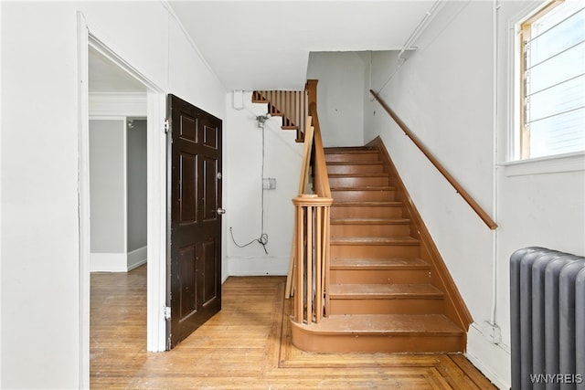 49 Urban St, Buffalo, NY 14211 - stairs featuring radiator heating unit and wood finished floors