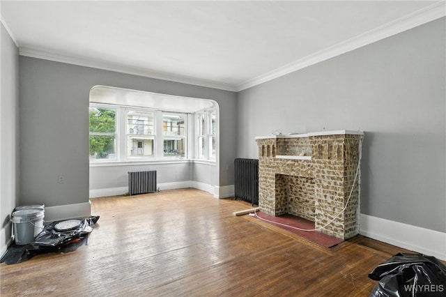 49 Urban St, Buffalo, NY 14211 - unfurnished living room featuring radiator heating unit, ornamental molding, hardwood / wood-style floors, and a brick fireplace
