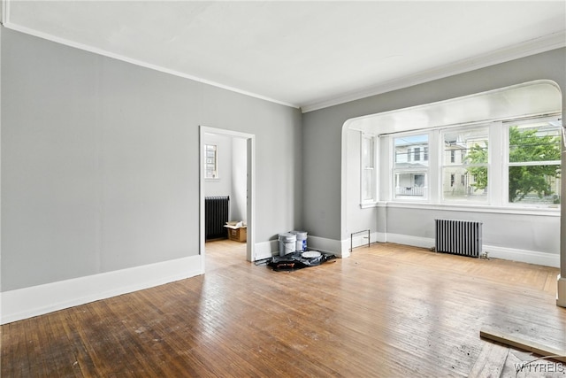 49 Urban St, Buffalo, NY 14211 - spare room featuring radiator heating unit, ornamental molding, and hardwood / wood-style floors
