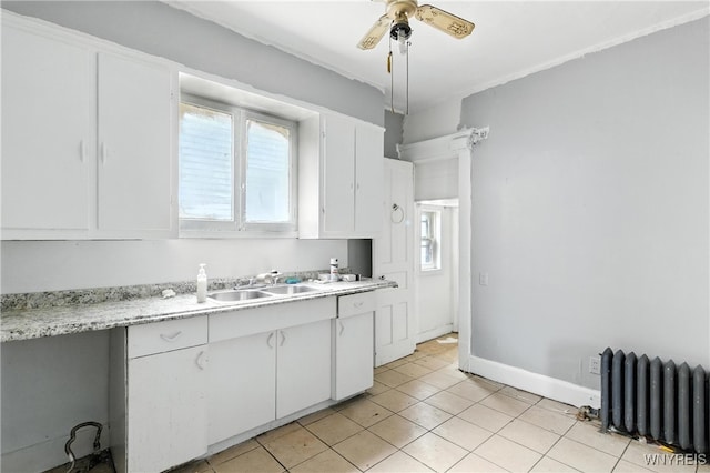 49 Urban St, Buffalo, NY 14211 - kitchen with radiator heating unit, dishwasher, light countertops, white cabinets, and ceiling fan