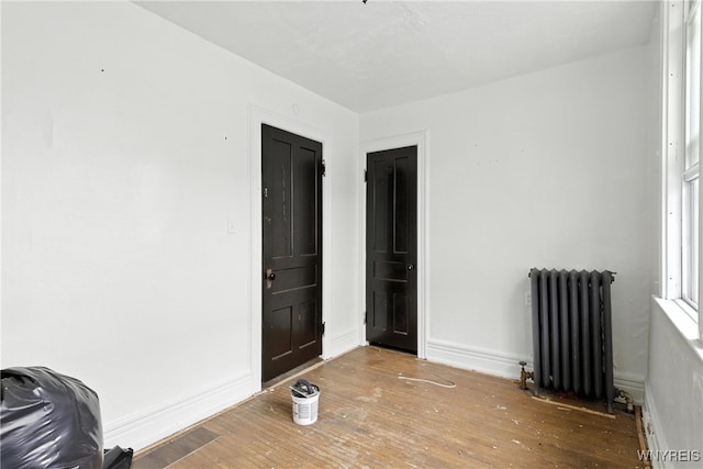 49 Urban St, Buffalo, NY 14211 - empty room featuring radiator heating unit and wood finished floors