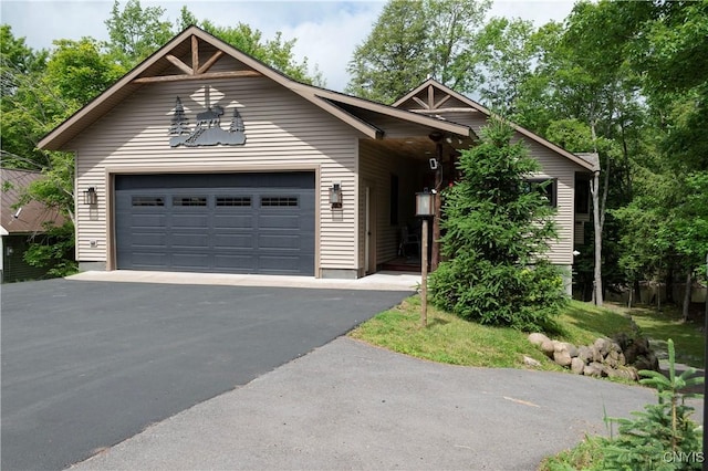 105 Garmon Ave, Webb, NY 13420 - view of front facade with an attached garage and driveway