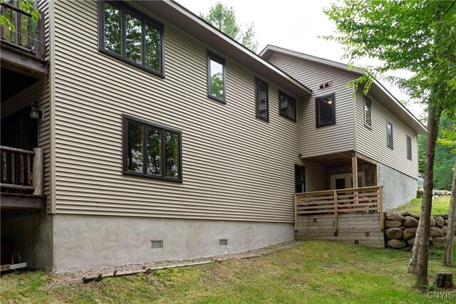 105 Garmon Ave, Webb, NY 13420 - view of side of home with crawl space and a lawn