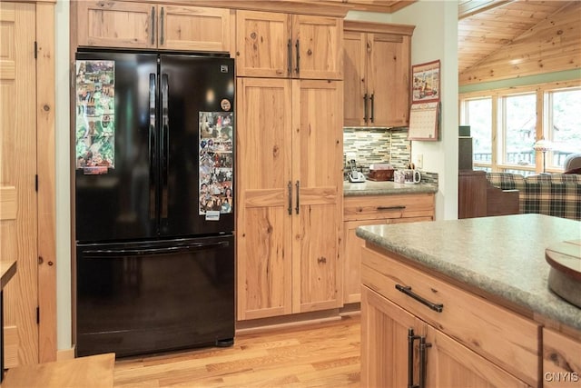 105 Garmon Ave, Webb, NY 13420 - kitchen featuring freestanding refrigerator, light wood finished floors, lofted ceiling, backsplash, and light brown cabinetry