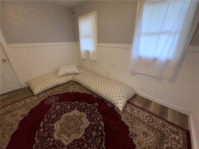 895 S Plymouth Ave, Rochester, NY 14608 - bedroom featuring wainscoting and wood finished floors