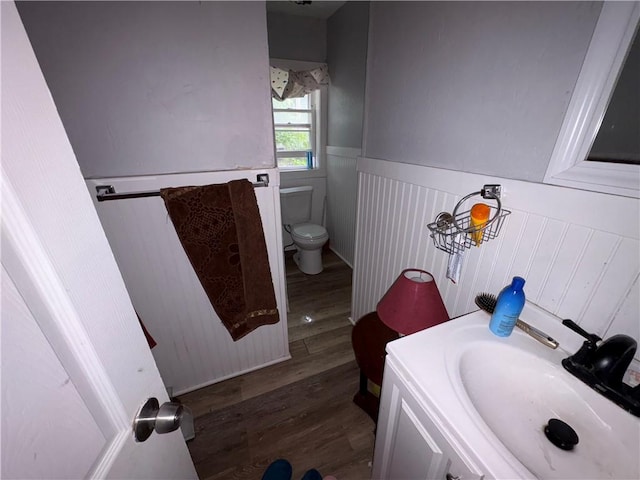 895 S Plymouth Ave, Rochester, NY 14608 - bathroom featuring wainscoting, wood finished floors, and vanity