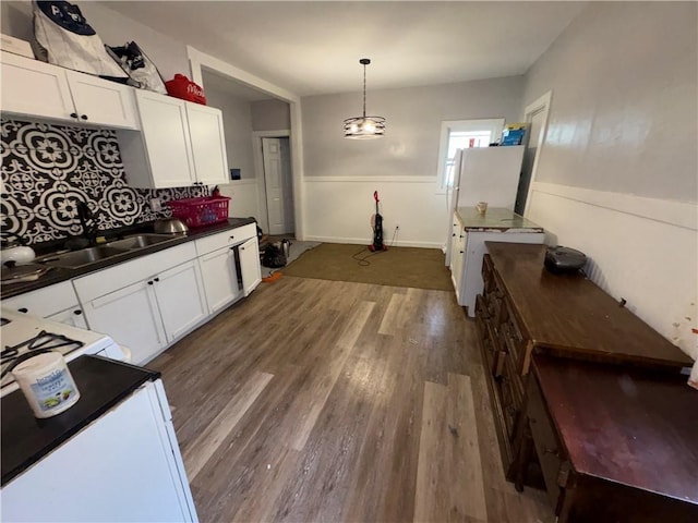 895 S Plymouth Ave, Rochester, NY 14608 - kitchen featuring dark countertops, dark wood finished floors, white cabinetry, wainscoting, and pendant lighting