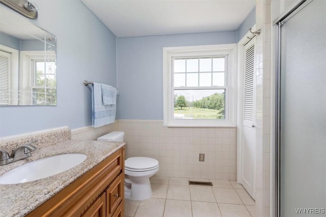 3212 Hickox Rd, Hamburg, NY 14075 - bathroom with tile walls, vanity, tile patterned flooring, a shower stall, and wainscoting