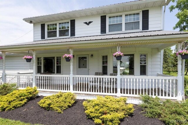 3212 Hickox Rd, Hamburg, NY 14075 - view of front facade with covered porch and a metal roof
