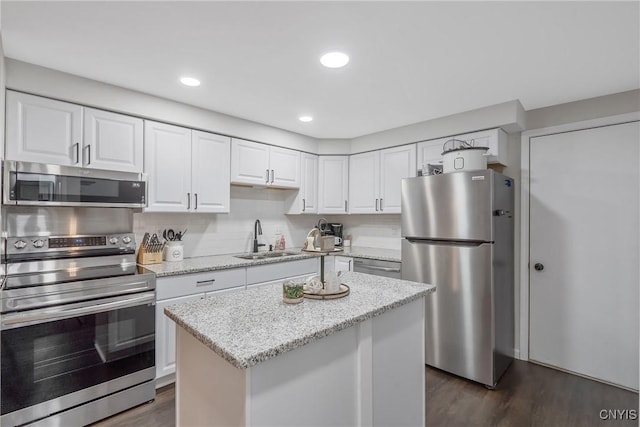 8433 Bubbling Springs Dr, Clay, NY 13027 - kitchen with stainless steel appliances, white cabinetry, dark wood-type flooring, light stone counters, and recessed lighting