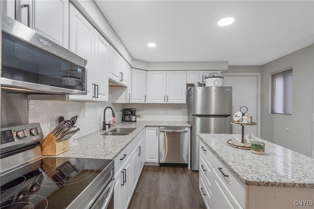 8433 Bubbling Springs Dr, Clay, NY 13027 - kitchen featuring appliances with stainless steel finishes, white cabinets, light stone countertops, and recessed lighting