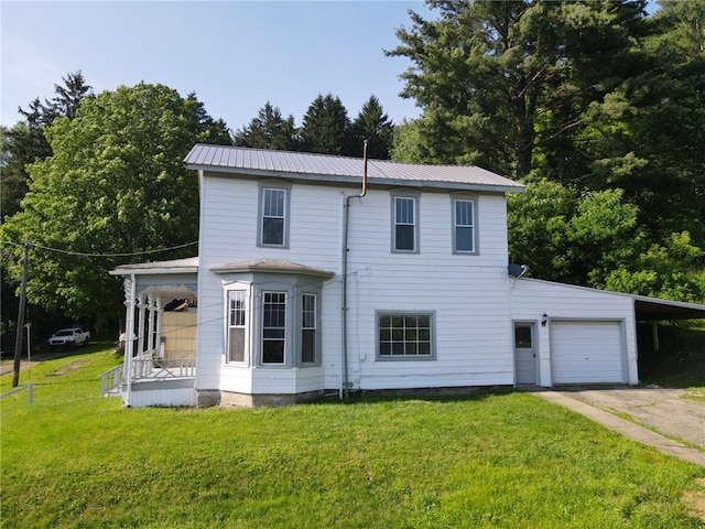 2 2nd St, Eldred, PA 16731 - rear view of house featuring a carport, a yard, a metal roof, driveway, and covered porch