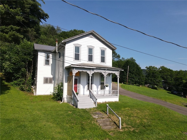 2 2nd St, Eldred, PA 16731 - view of front facade featuring a porch, a front yard, and a metal roof