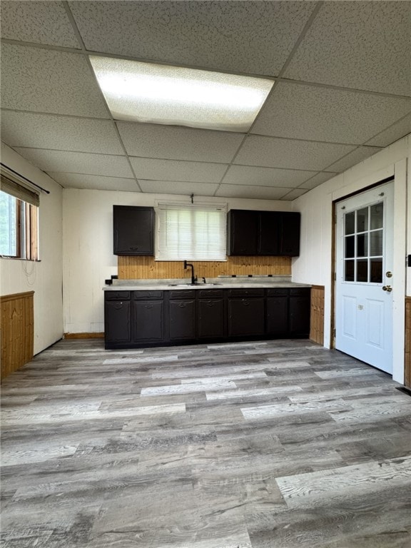 2 2nd St, Eldred, PA 16731 - kitchen featuring a paneled ceiling, light wood finished floors, wooden walls, light countertops, and dark cabinetry
