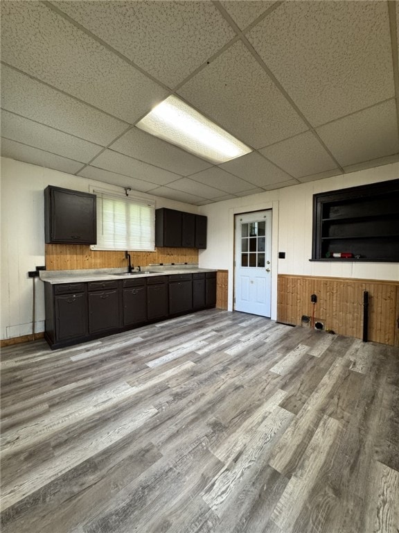 2 2nd St, Eldred, PA 16731 - kitchen with a drop ceiling, light wood finished floors, wooden walls, and light countertops