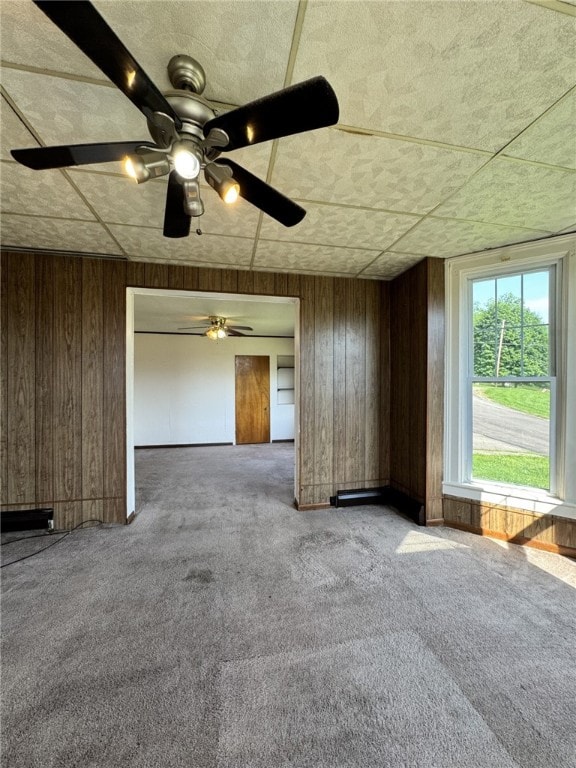 2 2nd St, Eldred, PA 16731 - unfurnished living room featuring carpet floors, wood walls, and a ceiling fan