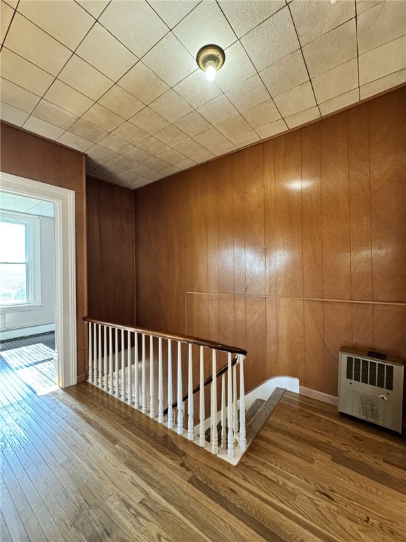 2 2nd St, Eldred, PA 16731 - hall with an upstairs landing, wood finished floors, wood walls, and a baseboard heating unit
