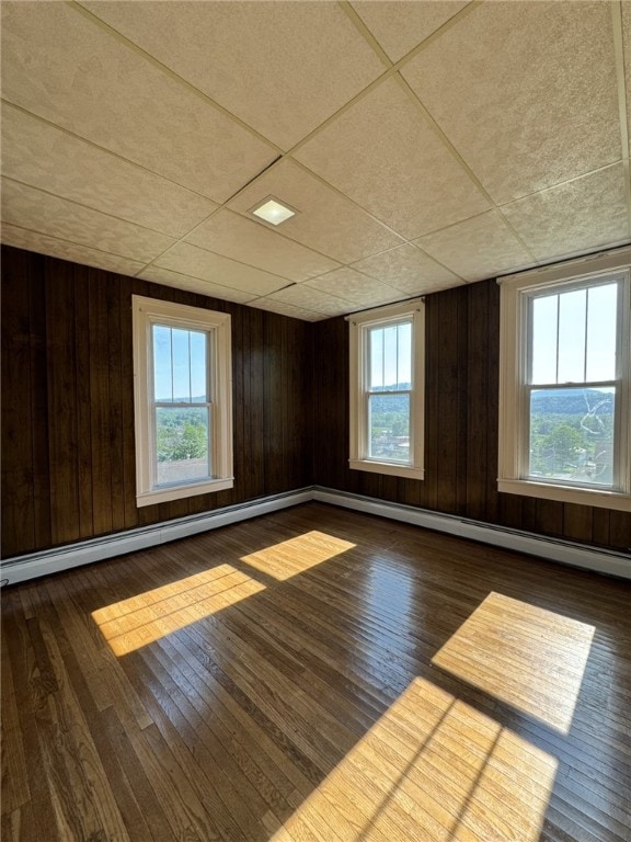 2 2nd St, Eldred, PA 16731 - unfurnished room with hardwood / wood-style flooring, baseboard heating, healthy amount of natural light, and wooden walls