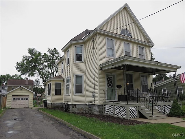 325 Margaret St, Herkimer, NY 13350 - view of front of home featuring covered porch, an outbuilding, driveway, and a detached garage