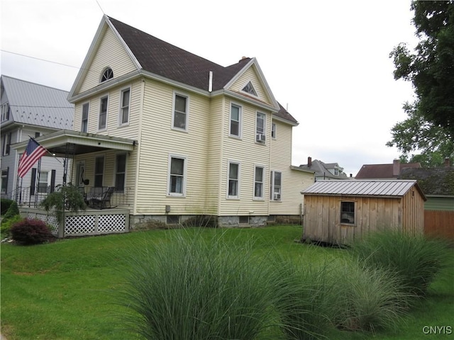 325 Margaret St, Herkimer, NY 13350 - rear view of property with a storage shed, a lawn, and a porch