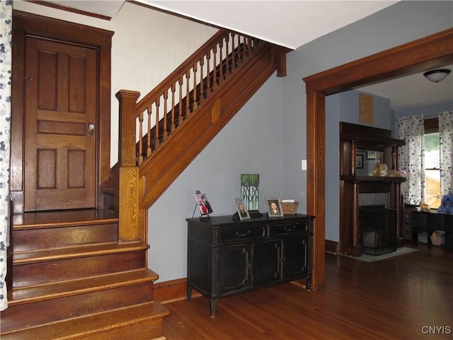 325 Margaret St, Herkimer, NY 13350 - staircase featuring wood finished floors and a fireplace with flush hearth