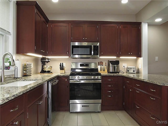 325 Margaret St, Herkimer, NY 13350 - kitchen with appliances with stainless steel finishes, recessed lighting, light stone countertops, light tile patterned flooring, and reddish brown cabinets