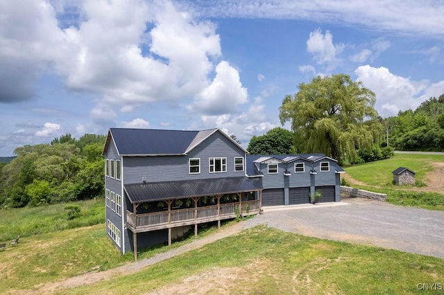 3785 Ransom Rd, Pompey, NY 13078 - view of front facade featuring a metal roof, driveway, a front lawn, and a garage